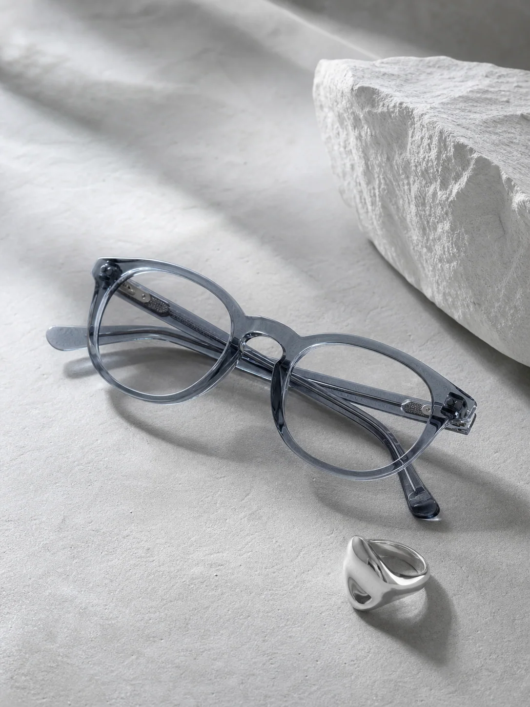 Transparent blue-gray eyewear with a silver ring