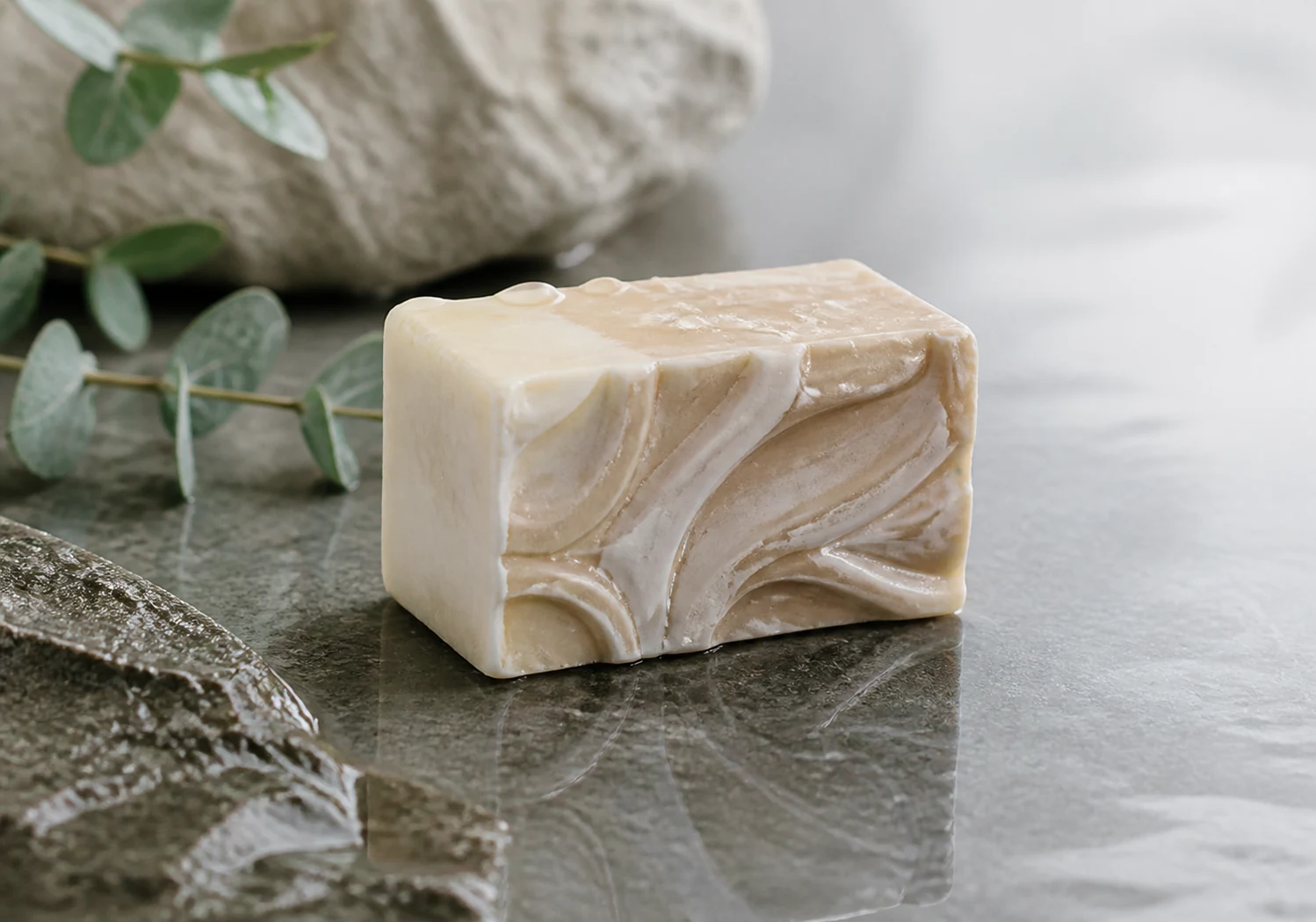 Soap resting on wet stone with soft reflection