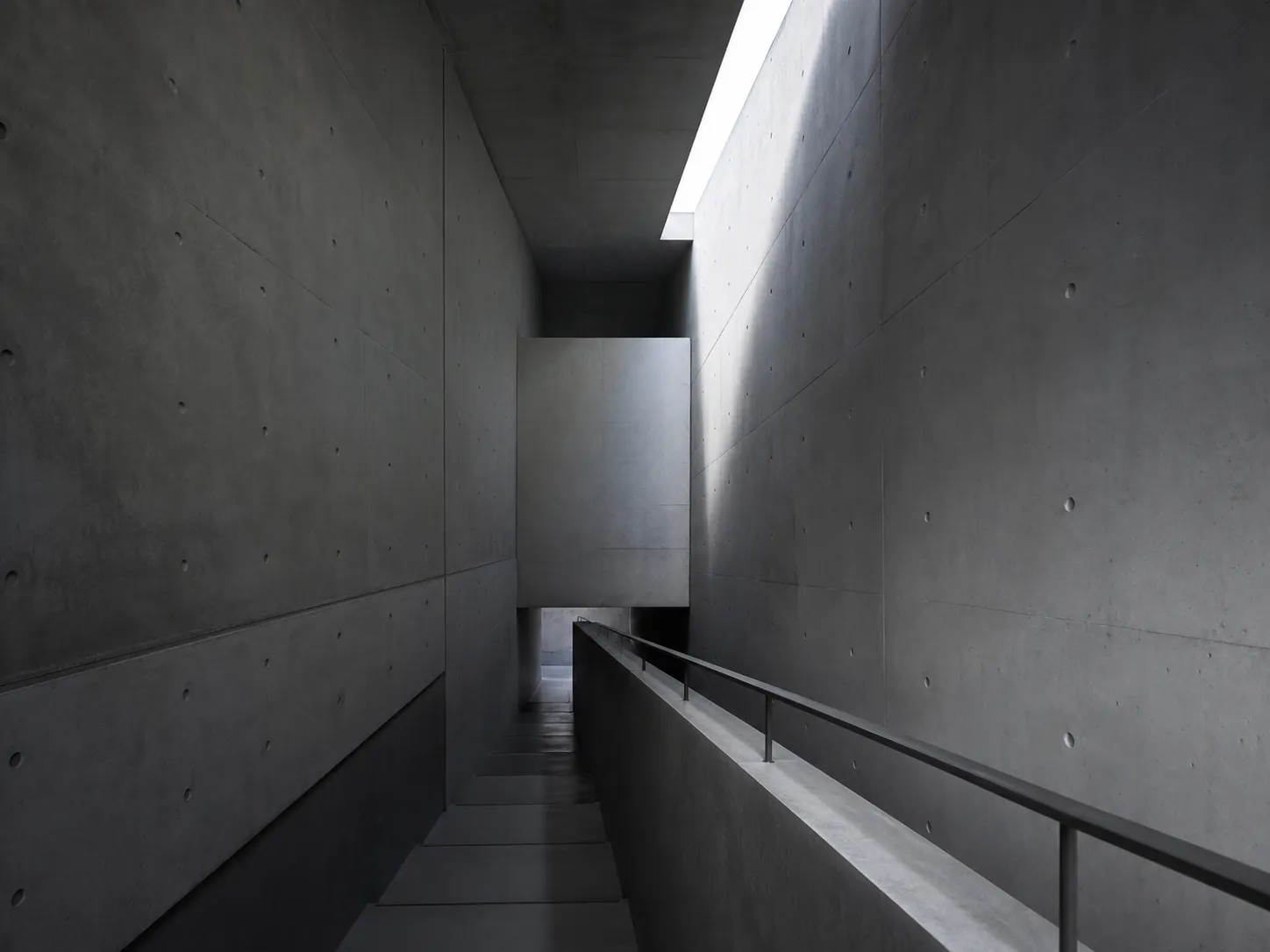 Tide Retreat concrete interior stair with a thin skylight