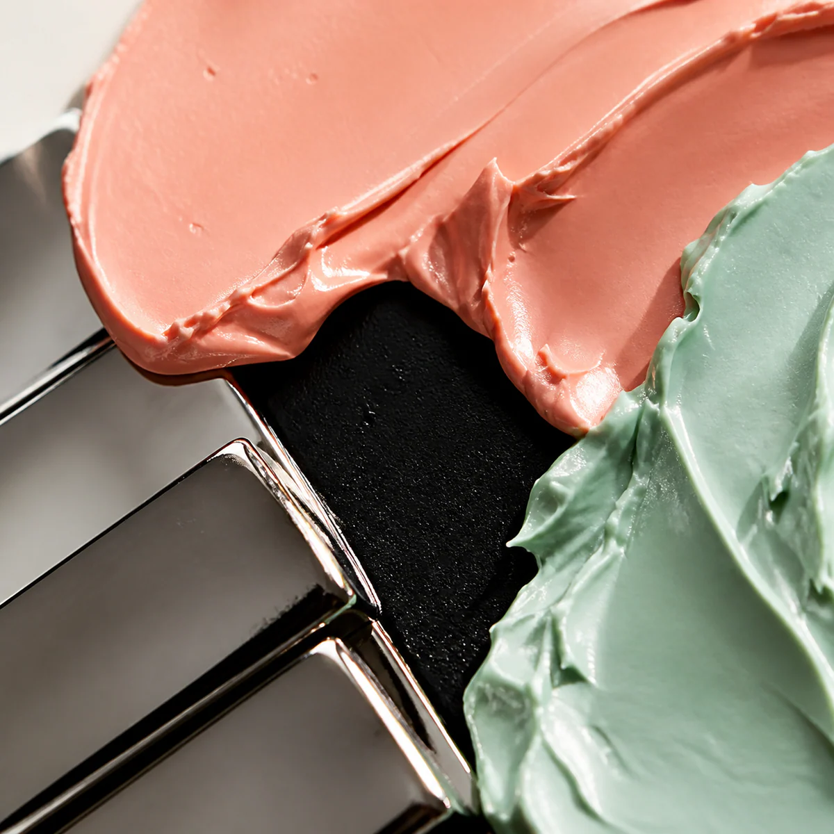 NOMA balm pigment texture with coral and mint surfaces