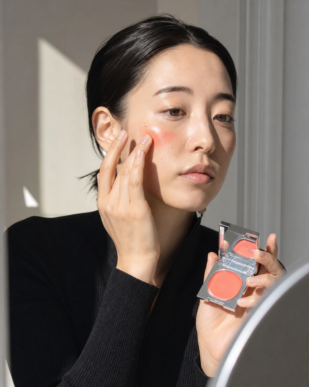 Korean model using NOMA balm in a studio campaign scene