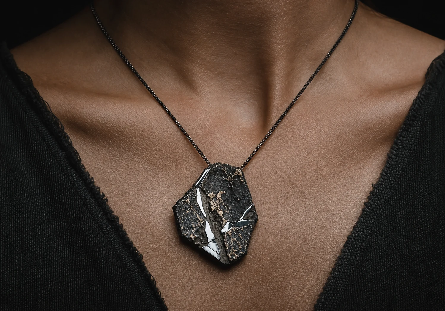 Fragment pendant worn on a neck.